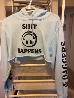Light Blue Cropped Hoodie with 'Shit Happens' Graphic